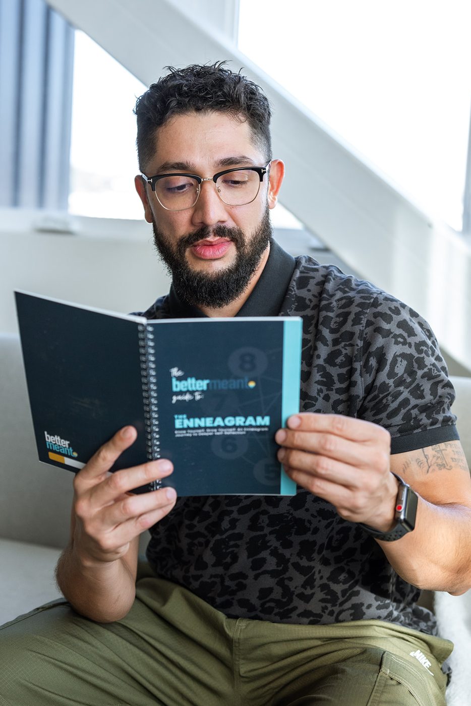 A man reading The Bettermeant Guide to the Enneagram